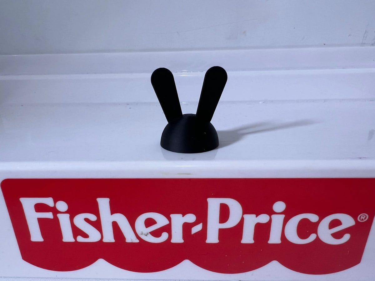 Black two-ear rabbit silhouette hat with rounded base and upright ear tips.