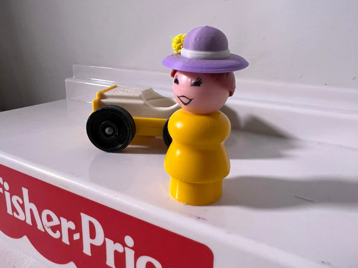 Purple summer hat with yellow flower, worn by a childlike figurine