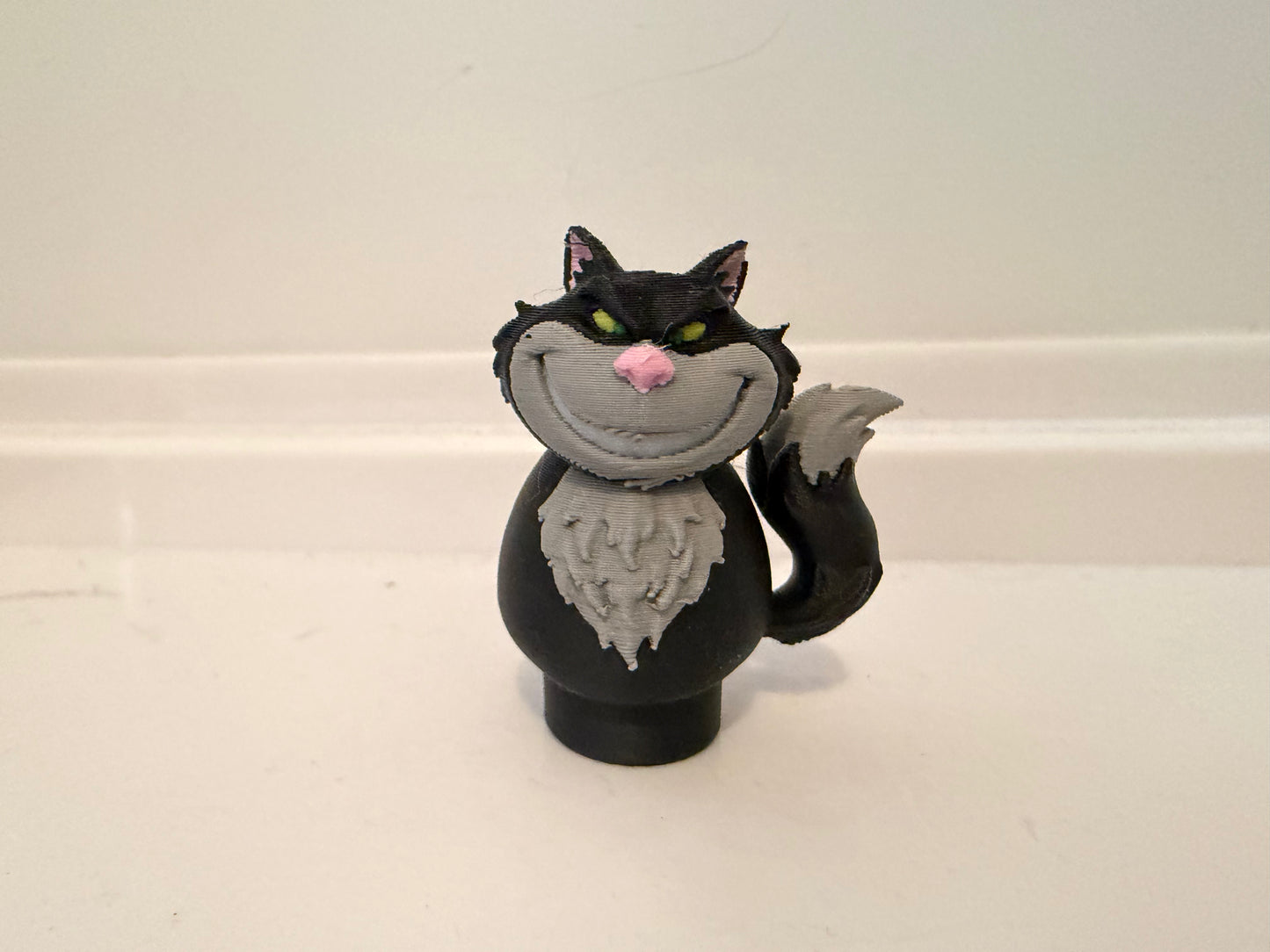 Lucifer black cat villain figure with gray collar and pink nose, standing