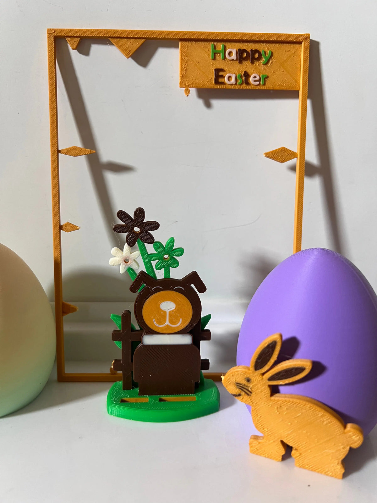 Easter wooden gift card with bear, flowers, fence post, and gold bunny figure on tray