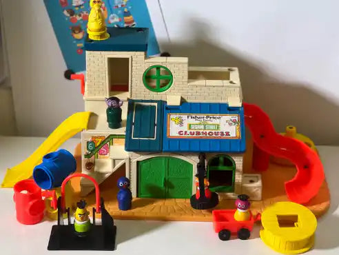 Colorful clubhouse toy playset with slide, vehicles, and character figures