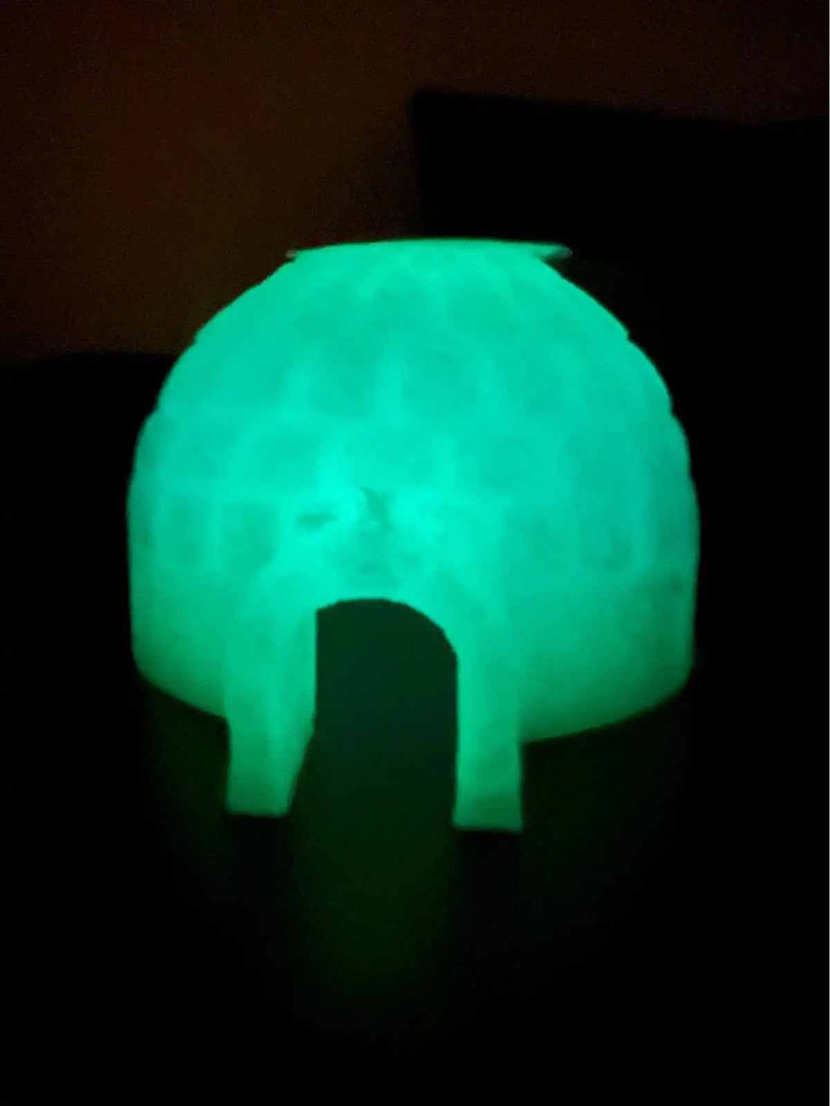 Glowing green translucent igloo-shaped holiday toy with arched doorway