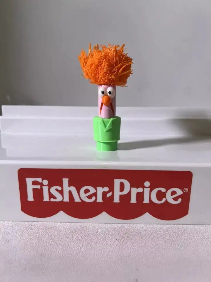 Standing Muppets Beaker toy with orange hair, pink face, orange beak, green body
