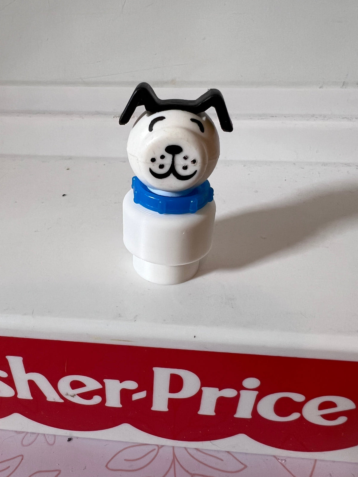 White Lucky/Fido dog figure with blue collar and black ear accents