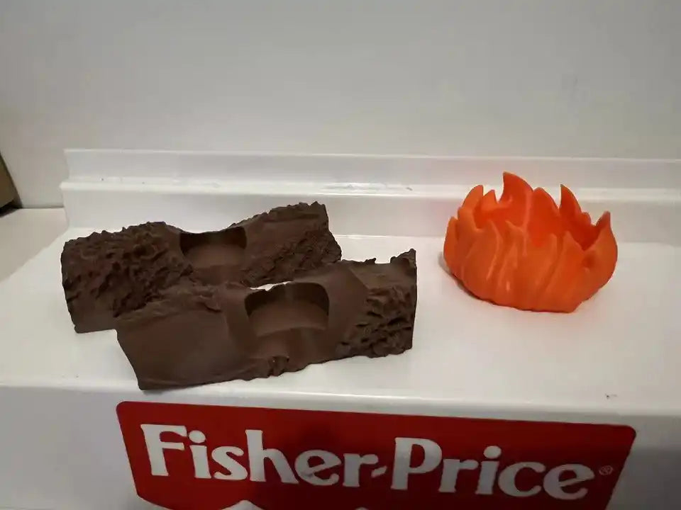 Orange campfire flame beside brown logs on Fisher-Price tray