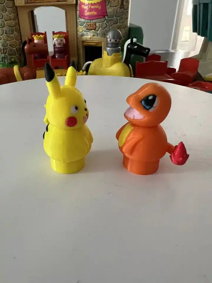 Charmander toy figurine, orange with blue eyes, red hands, and curled tail, facing left.