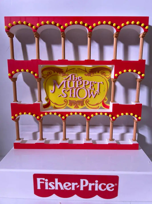 A custom 3D printed Muppets Display Stand in red and yellow with arches and "The Muppet Show" sign, by Fisher-Price.