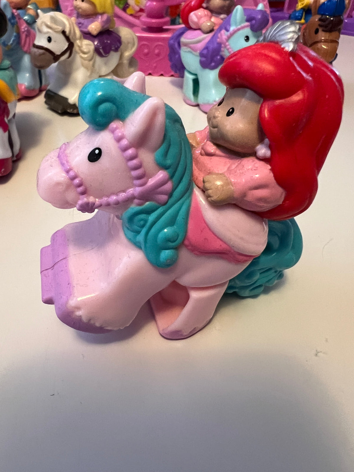 Little People rider figure with red hair on light teal horse, molded toy