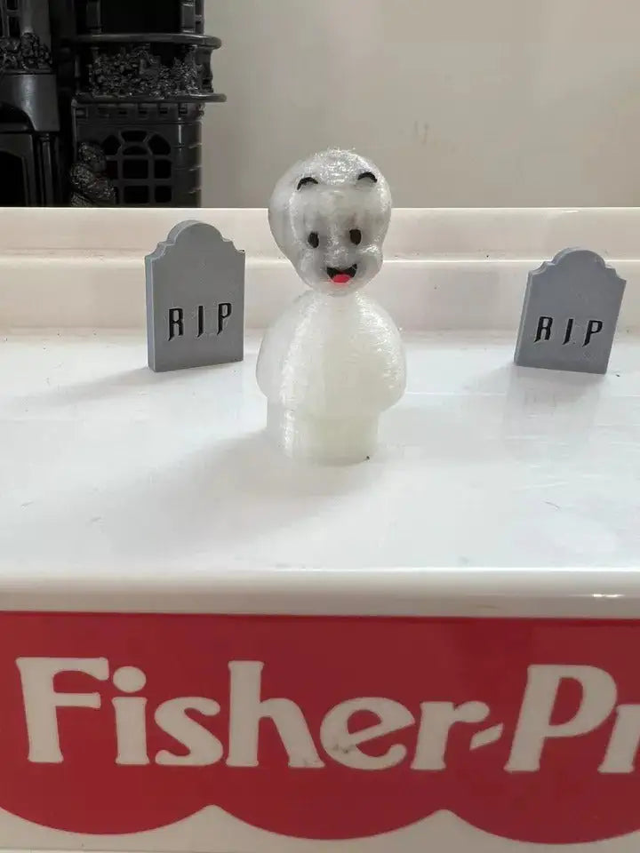 White Casper the Friendly Ghost figurine with dark eyes and red mouth.
