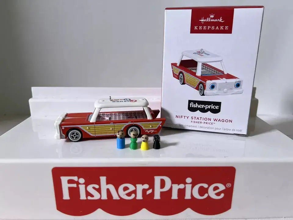 Mini station wagon ornament in red, yellow, and white with four small passenger figures