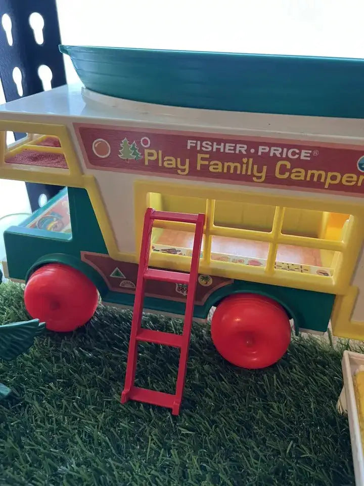 Red plastic camper ladder with three steps, shown attached to the playset