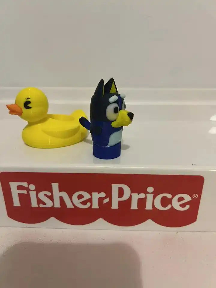 Bluey plush hand puppet and yellow duck toy, side-by-side on tray