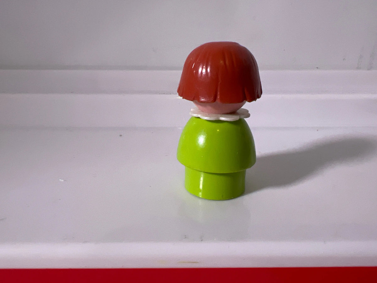Lime green girl figure with red bob hair, back view