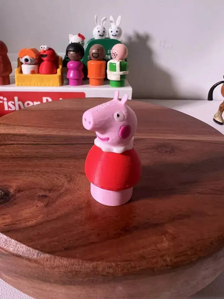 Pink pig figurine in red top with snout and ears, shown front