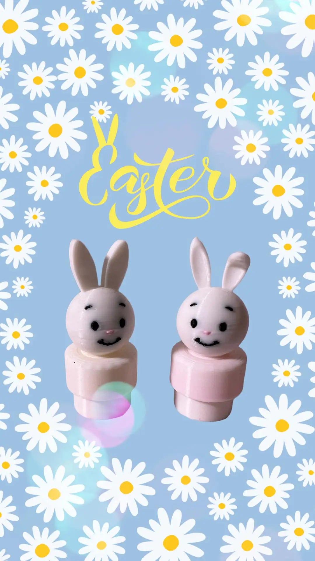 Pair of small bunny toy figures with white faces and pink bodies
