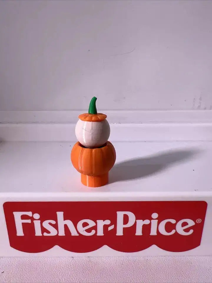 Orange pumpkin character figurine with green-stem cap and round white face