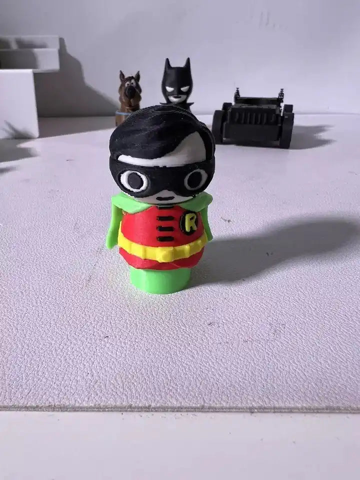 Robin character plush figure with black mask, green cape, red-and-yellow tunic.