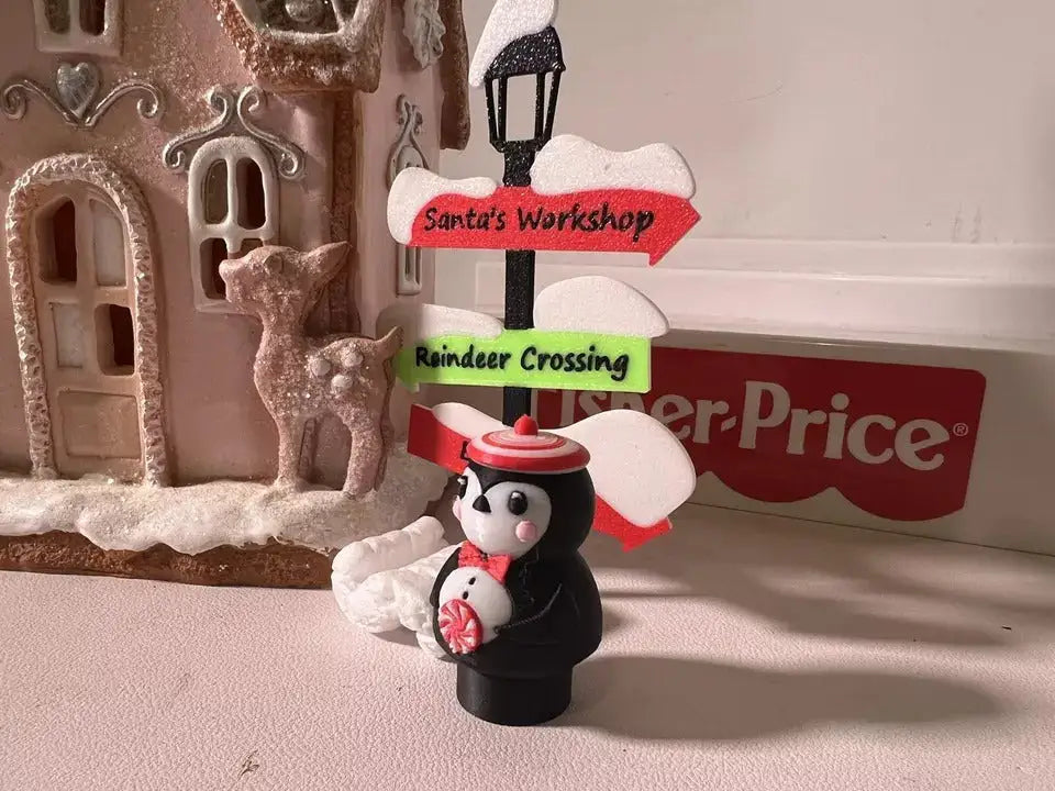 Peppermint penguin holiday figurine with red-and-white hat and peppermint candy badge