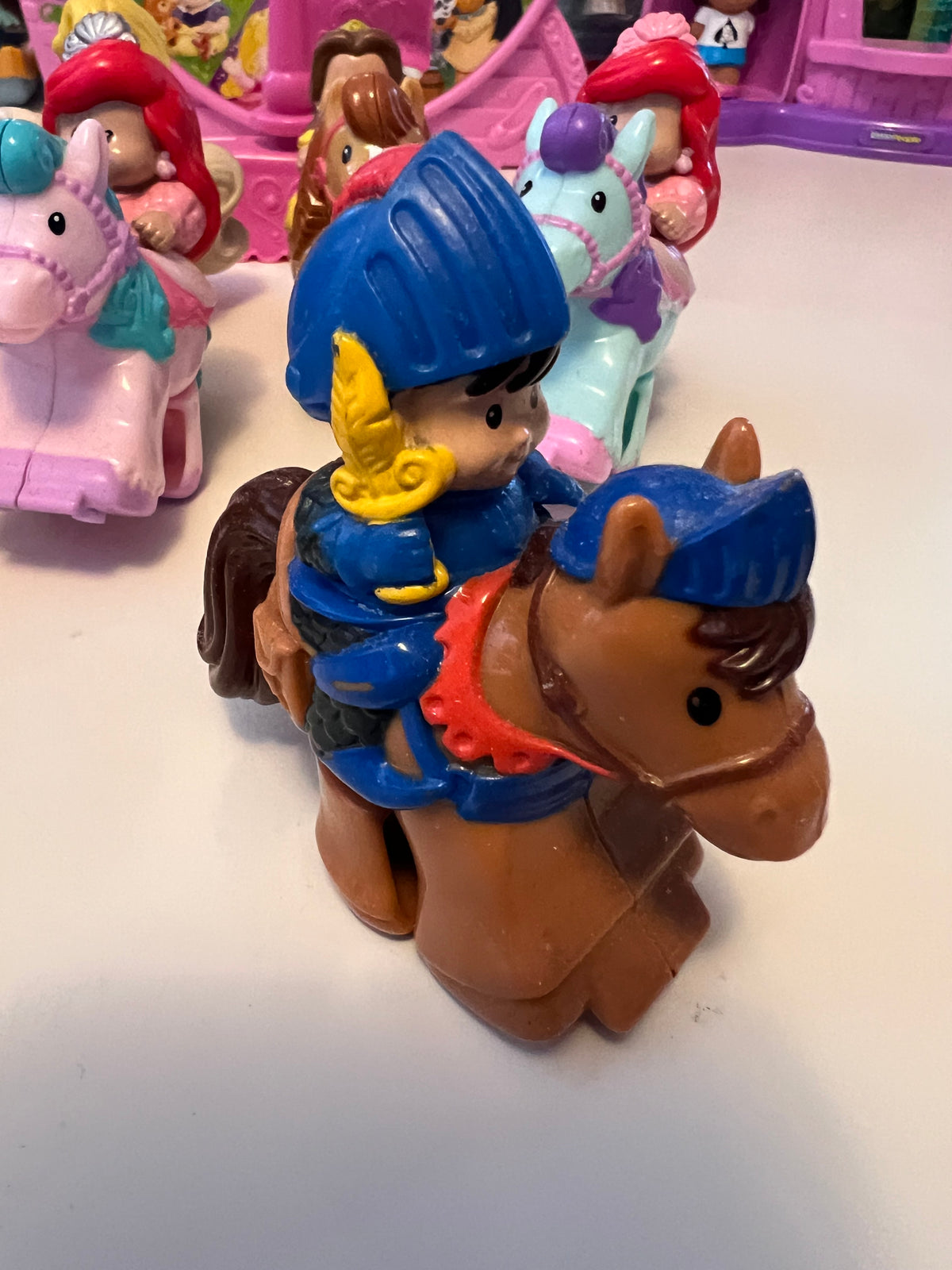 Little People rider figure with blue hat on brown horse, molded toy