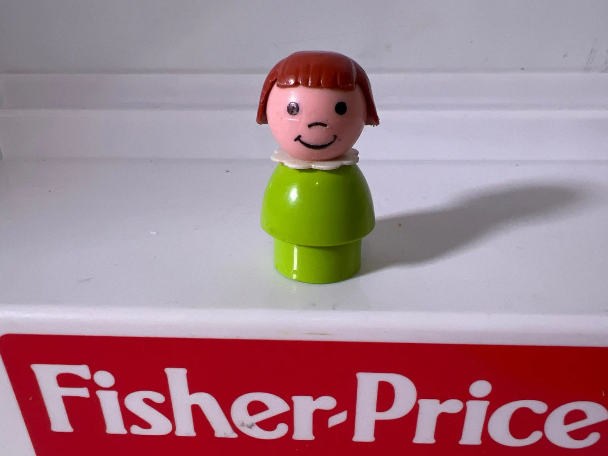 Lime green girl figure with red bob hair and smiling face