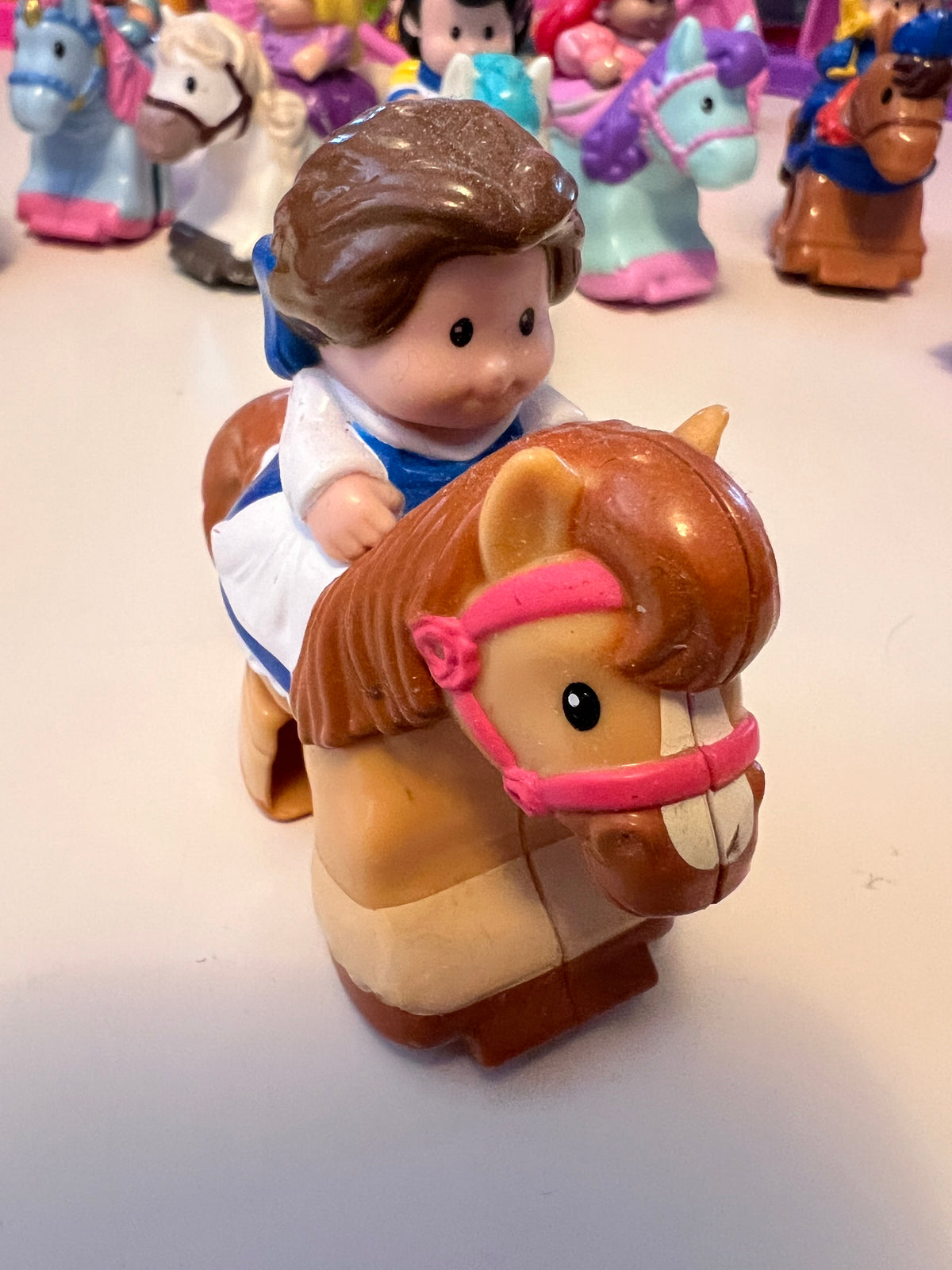 Fisher-Price Little People character figurine holding brown horse
