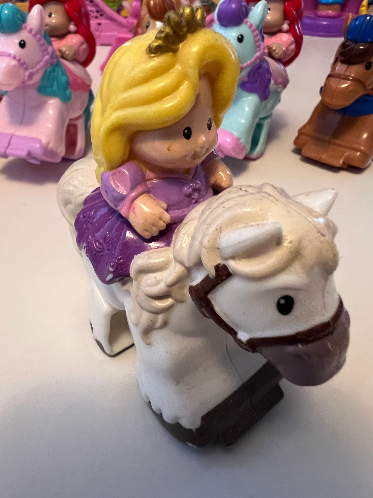 Little People rider figure with blonde hair on white horse, molded toy
