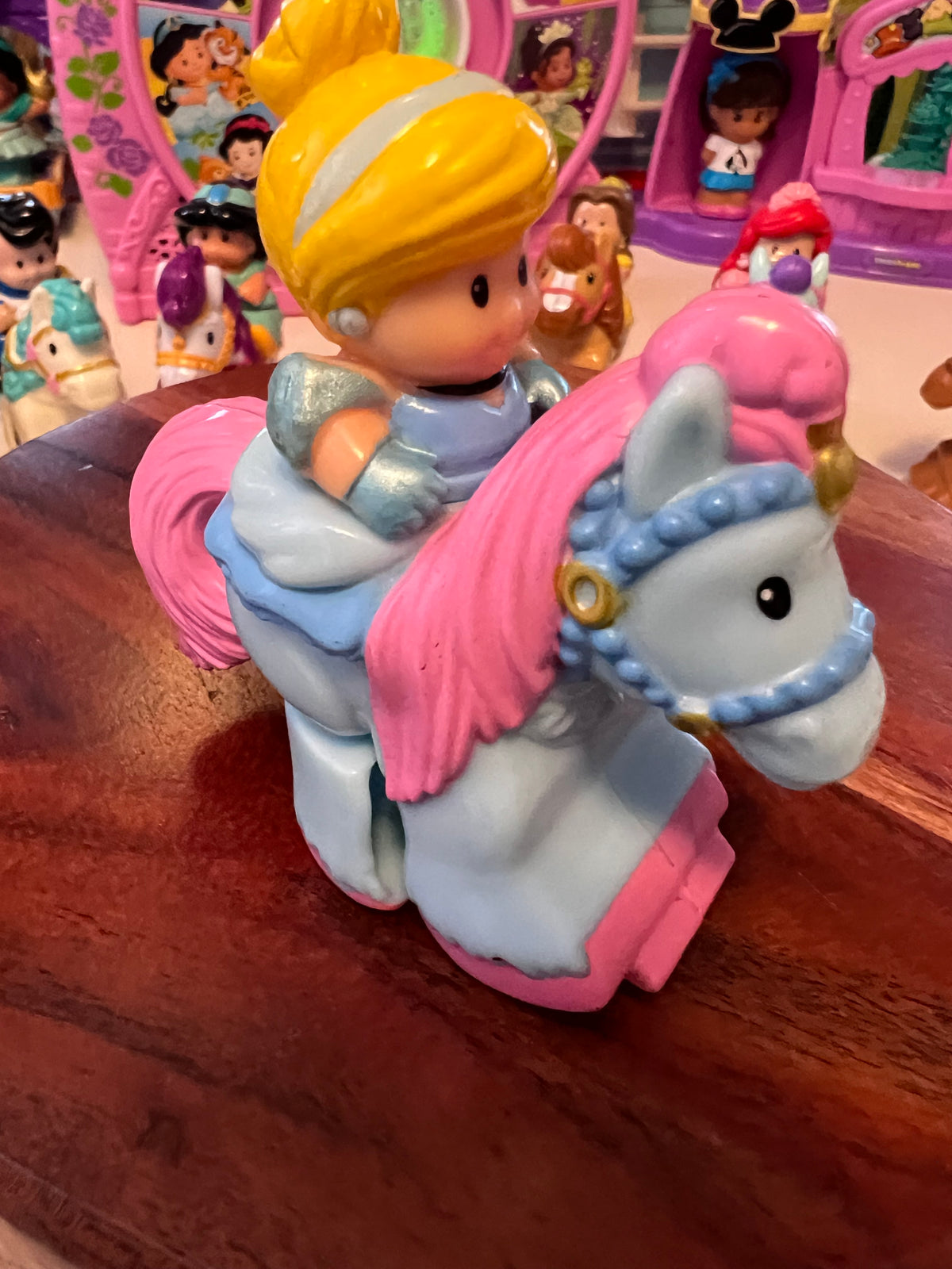 Little People rider figure with yellow hair on pink horse, molded toy