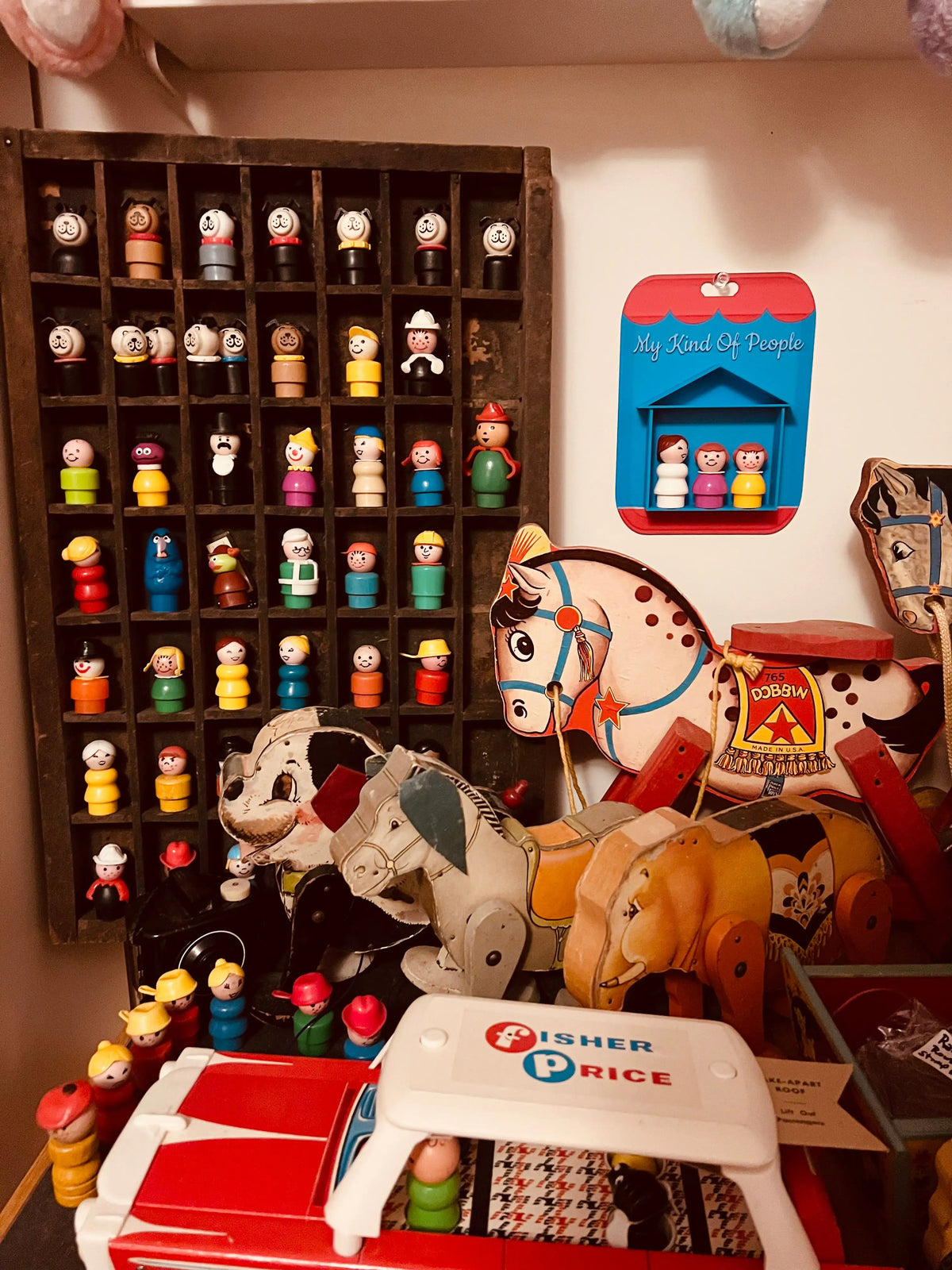 Blue and red themed display card with three small people figures in window