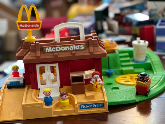 McDonald's restaurant toy playset with red building, open windows, and beige base