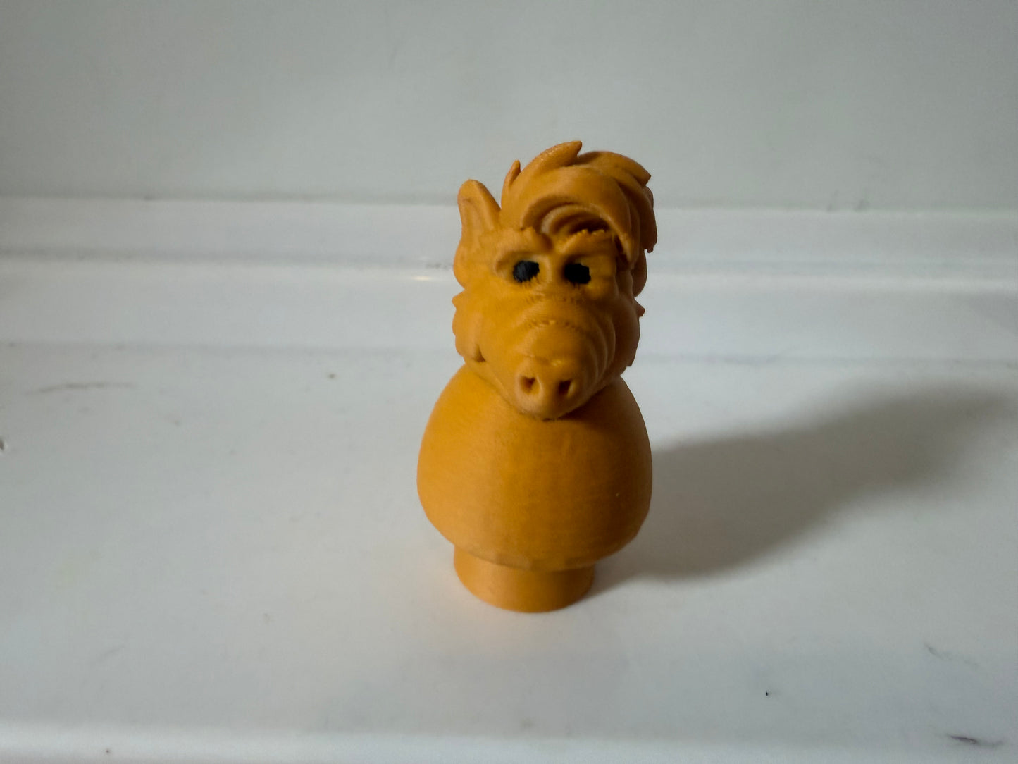 Vintage Alf figure toy in orange-brown, front view with sculpted face