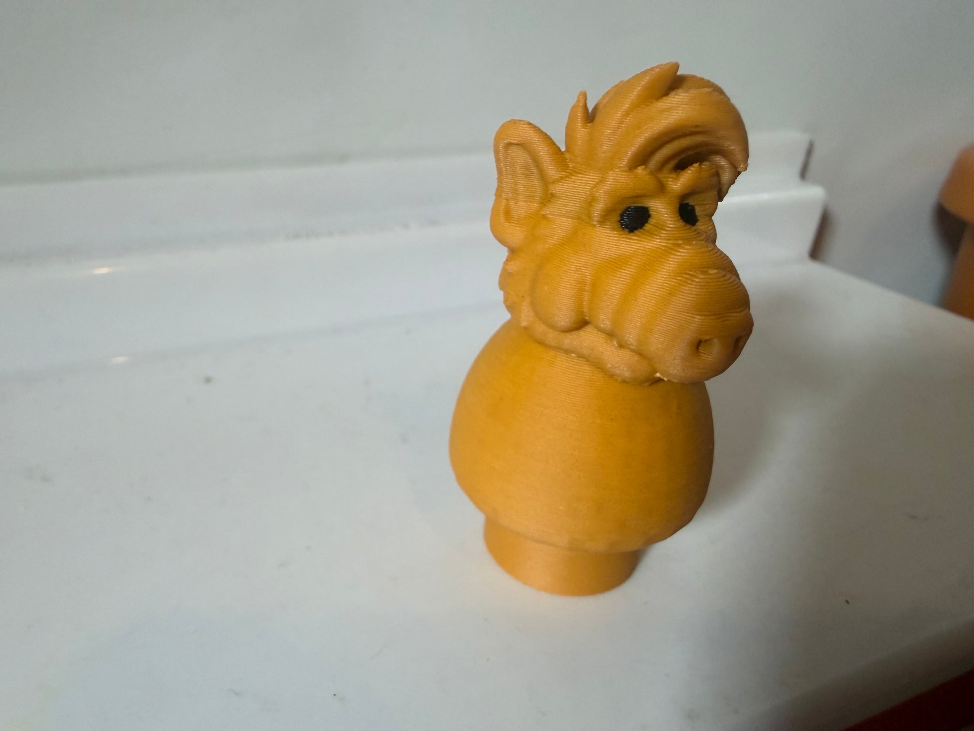 Vintage Alf figure toy in orange-brown, head and shoulders close-up