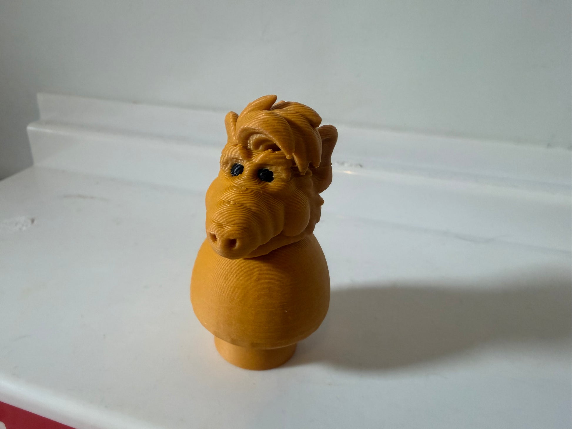 Vintage Alf figure toy in orange-brown, side profile stance