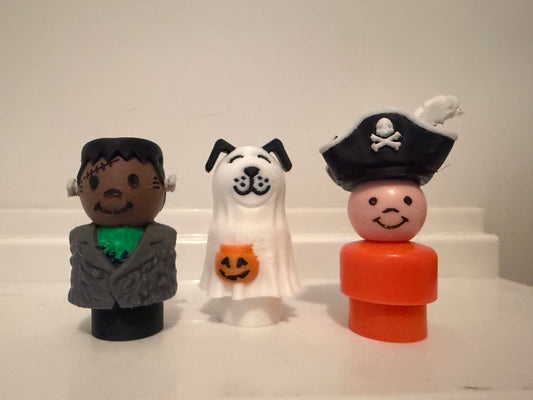 Set of three mini Halloween costume figures: pirate, ghost, and Frankenstein.