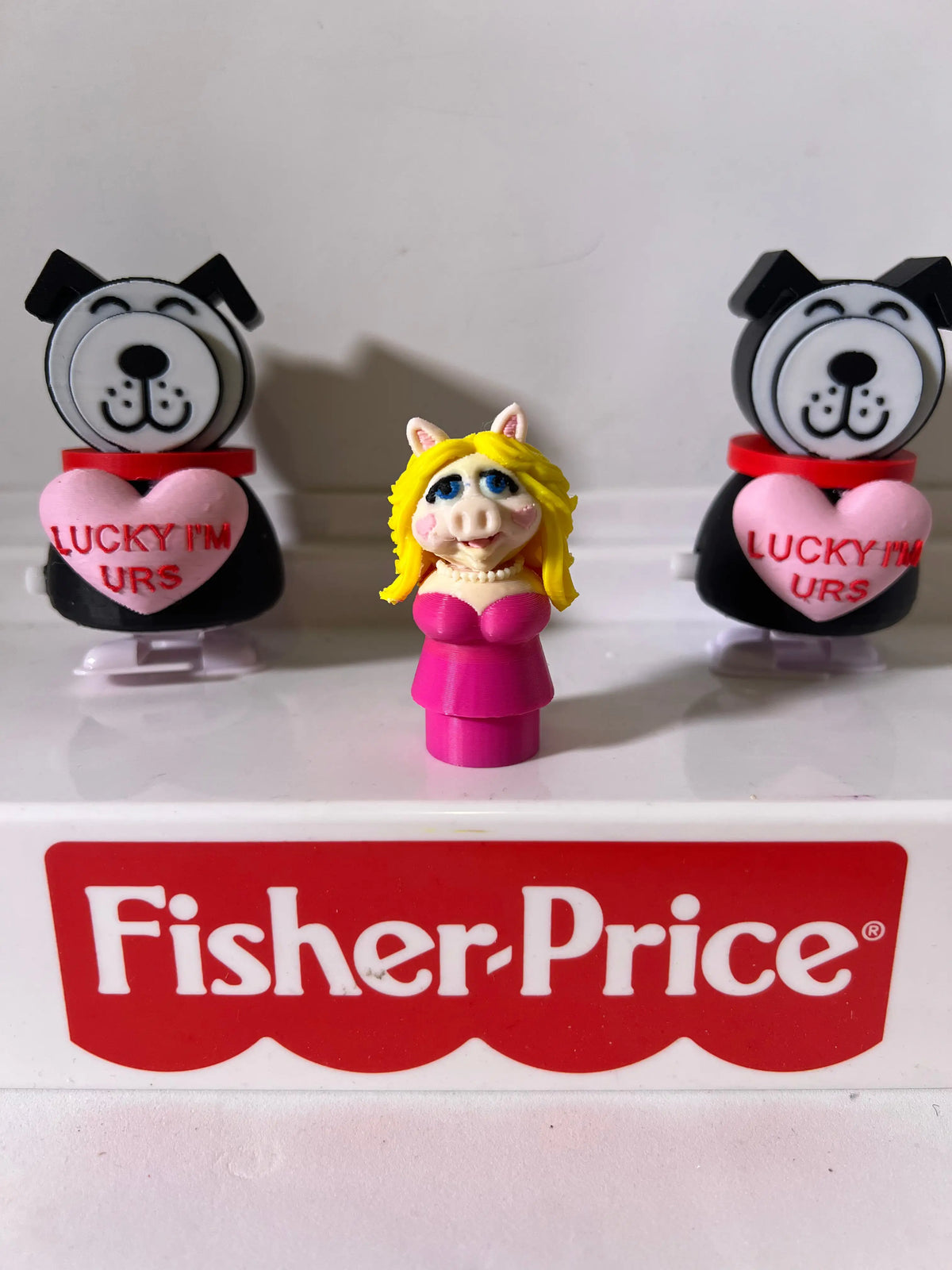 A custom 3D-printed Miss Piggy Little People figure in a pink dress