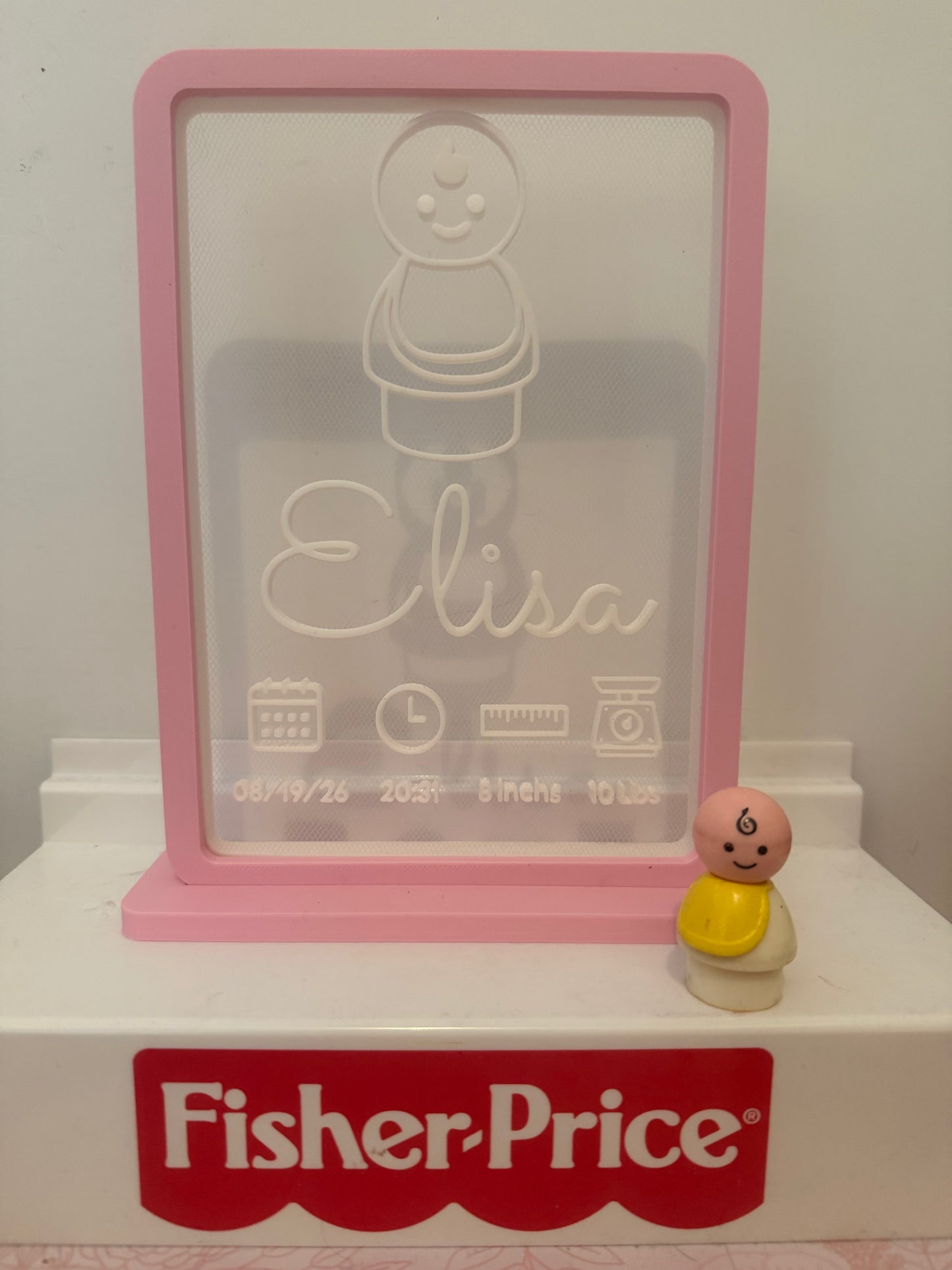 Pink birth sign with engraved bear and name Lisa; date/time icons; Fisher-Price base