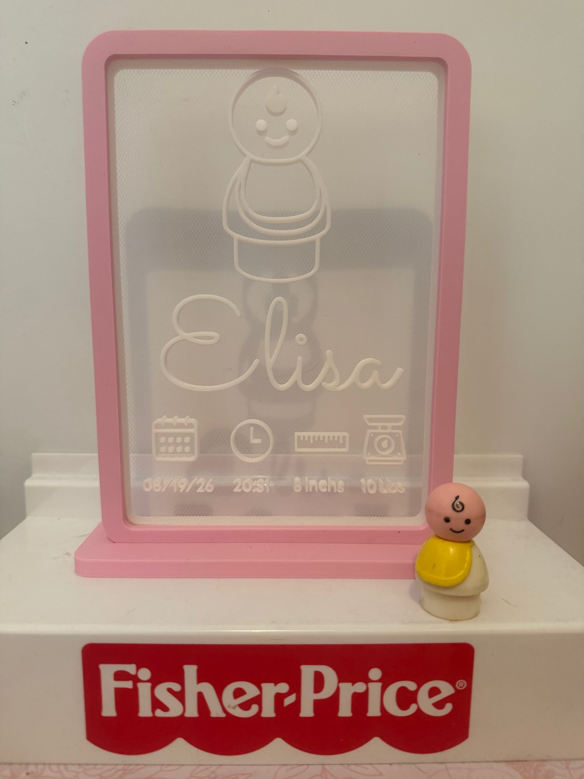 Pink birth sign with engraved bear and name Lisa; date/time icons; Fisher-Price base