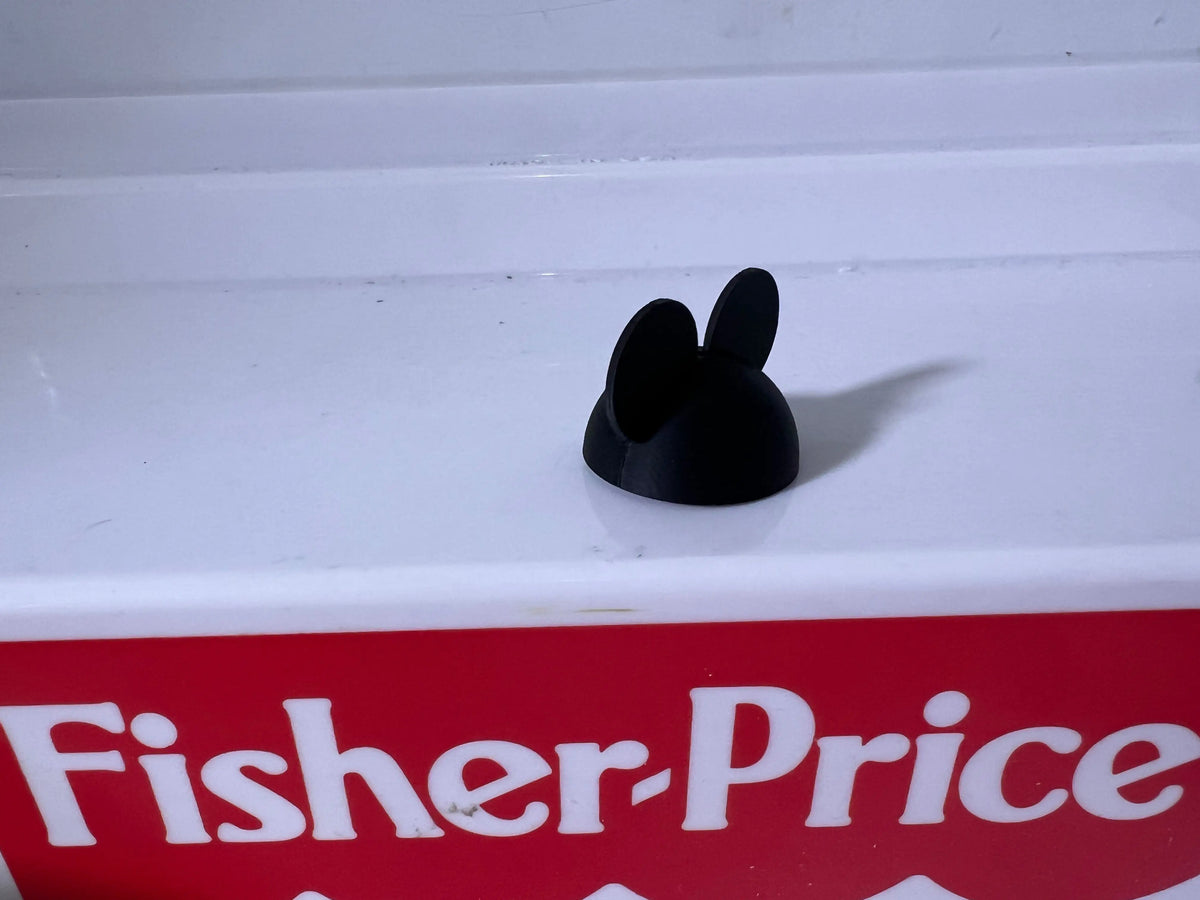 Black Mickey Mouse ear hat accessory, close-up top view