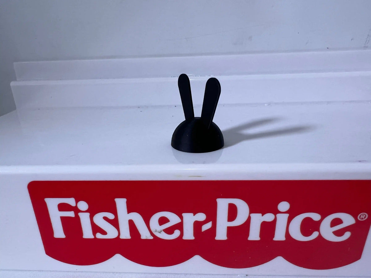 Black rabbit-ear hat, featuring two upright ears atop a rounded base.