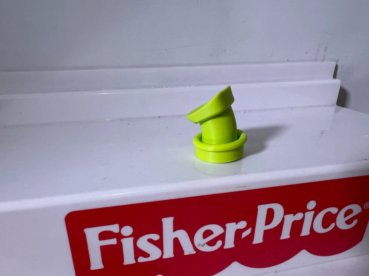 Neon green pointed goofy hat accessory on white display shelf