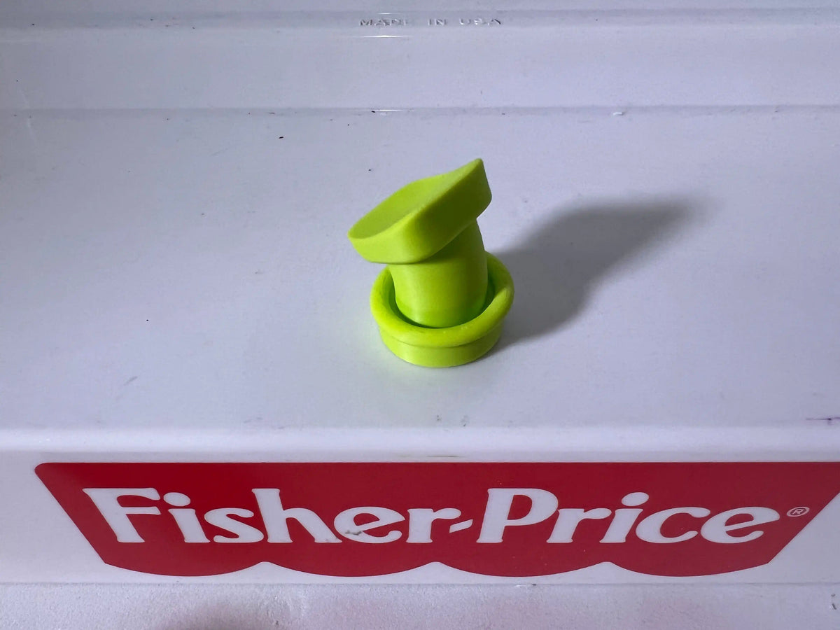Neon green goofy hat accessory, folded curled top on white shelf