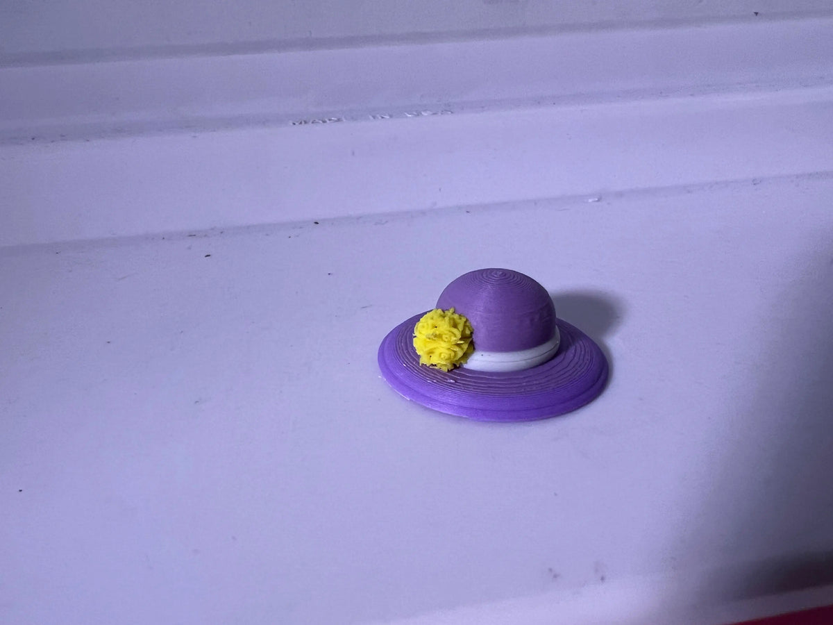 Purple summer hat with wide brim and yellow flower accent