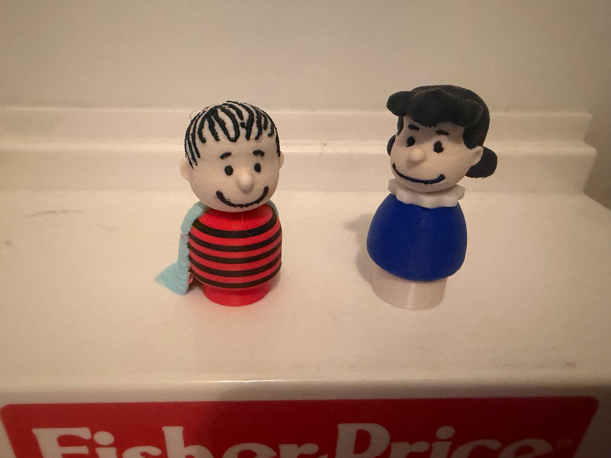 3D Linus collectible figure, side view, with striped shirt and blue blanket