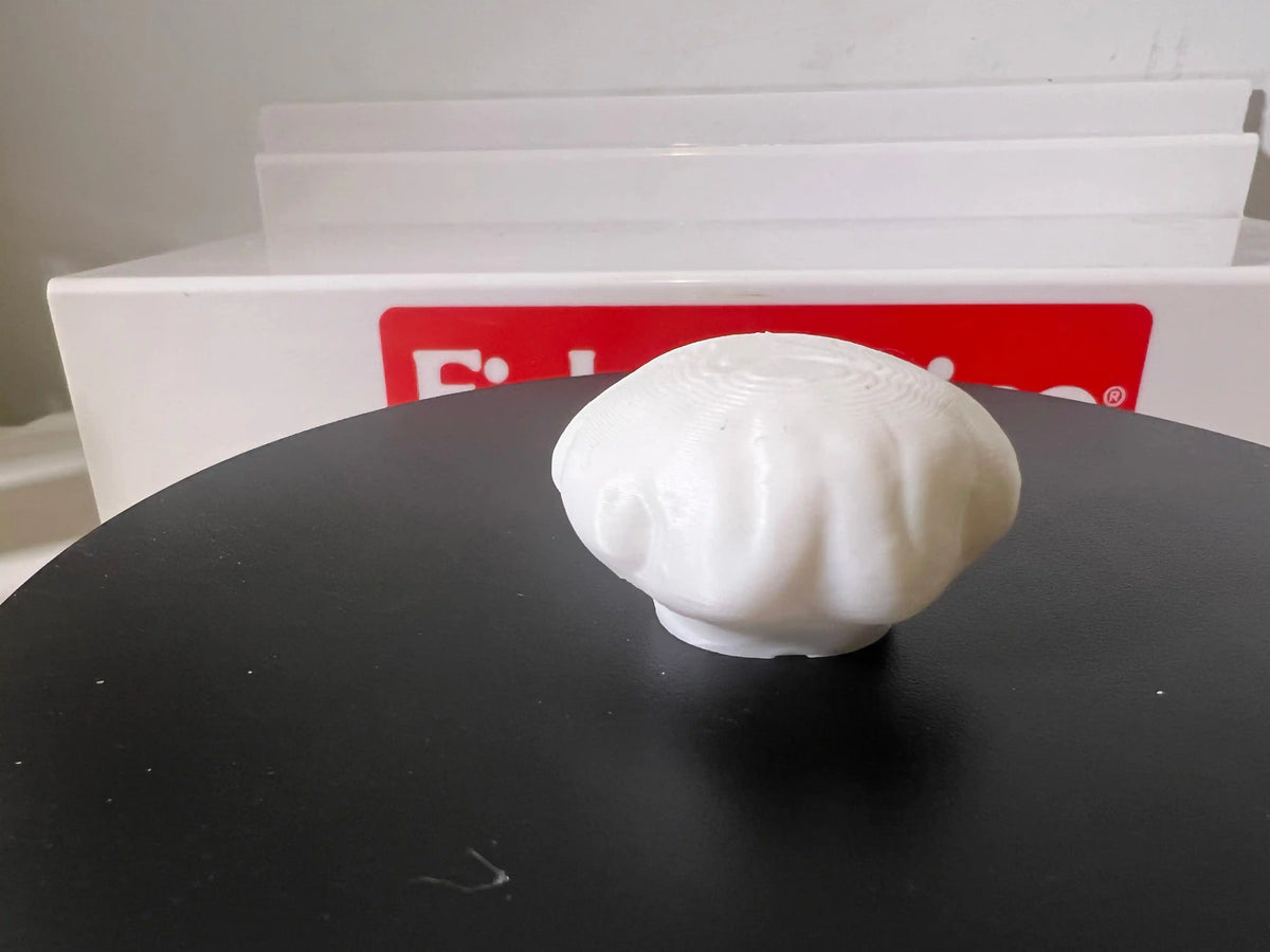 Miniature white chef hat close-up, rounded crown with soft folds