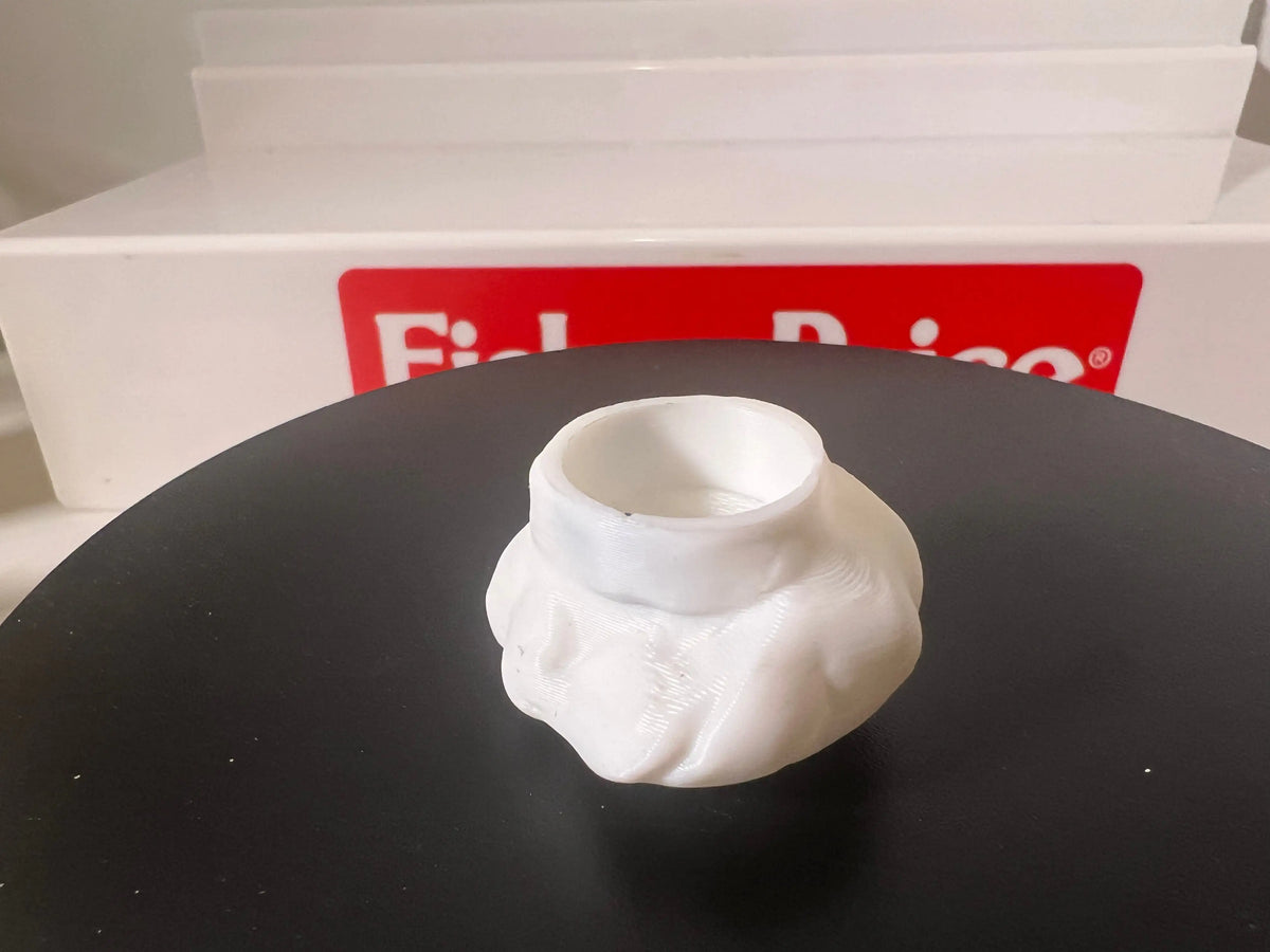 Miniature white chef hat close-up, open rim facing upward