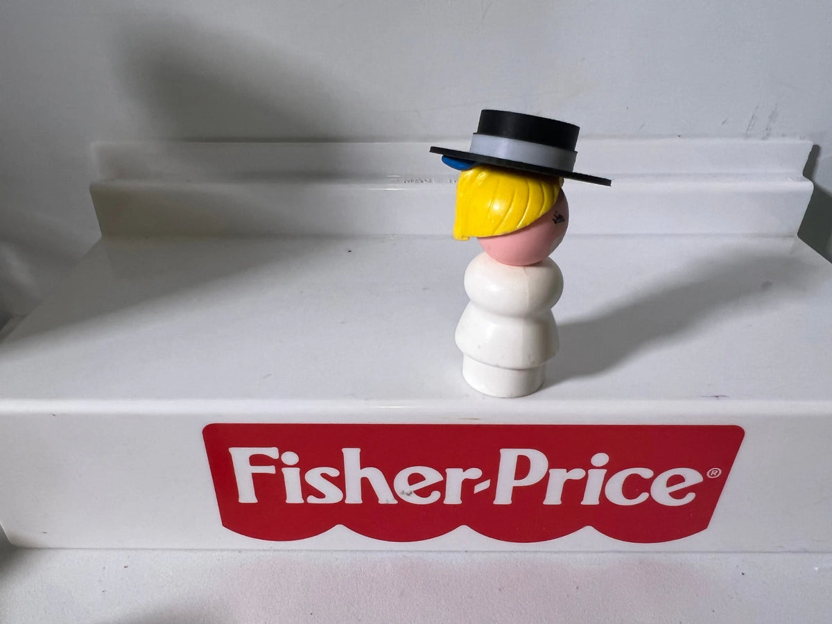 Vintage figure with black top hat and yellow hair, with Fisher-Price logo label below