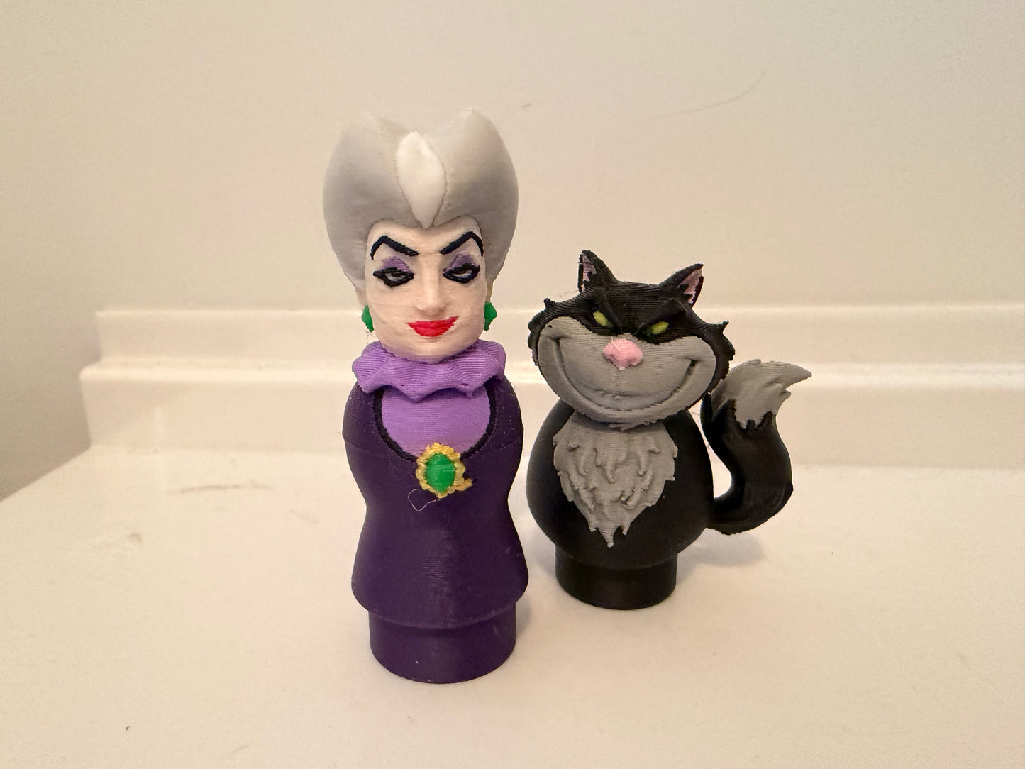 Lucifer villain figures set: purple queen woman beside black cat figure