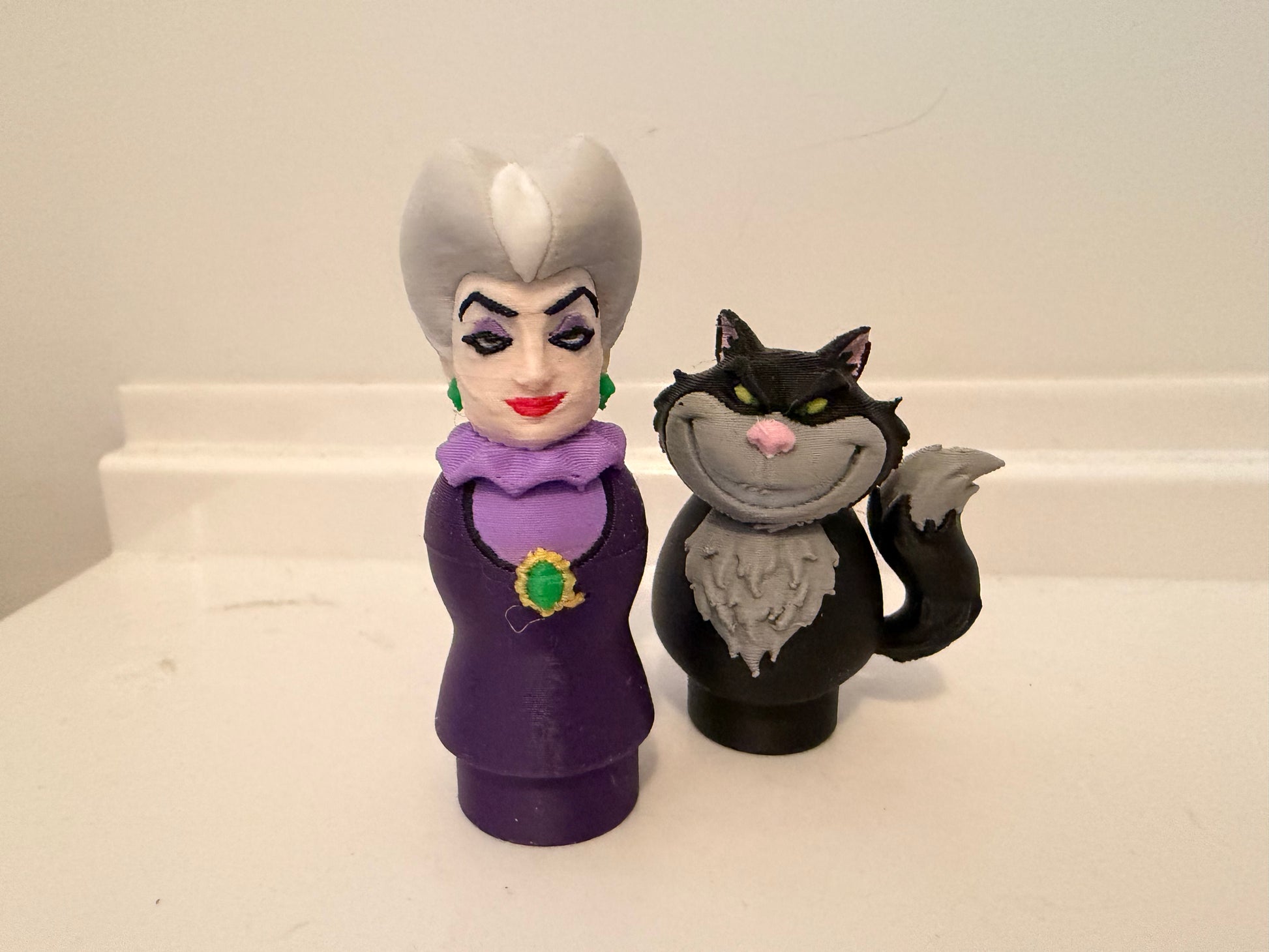 Lucifer villain figures set: purple queen woman beside black cat figure