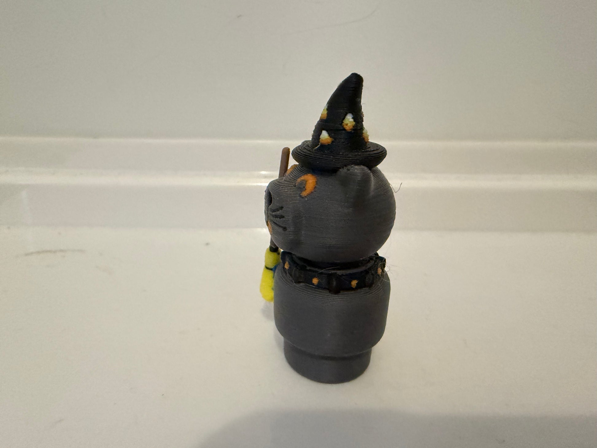 Halloween sorcerer cat figure facing front-left with black witch hat and gray outfit details