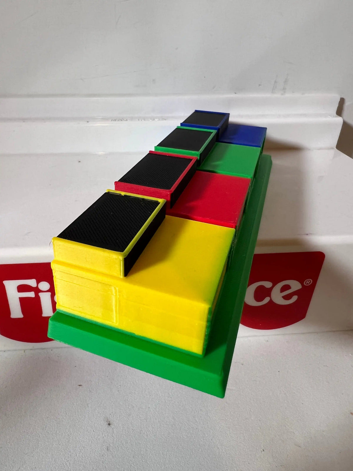 Game show podium row with yellow, green, red, and blue blocks on base
