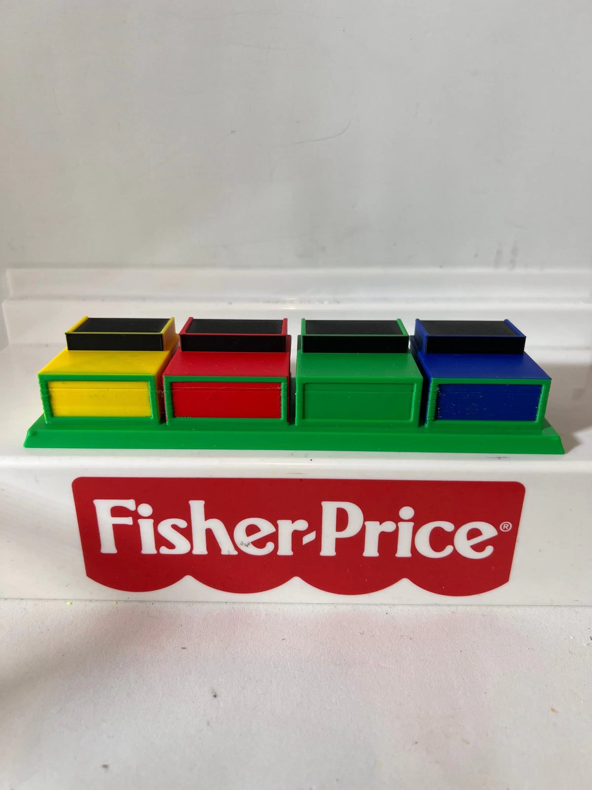 Fisher-Price game show contestant row with colored podium blocks on base